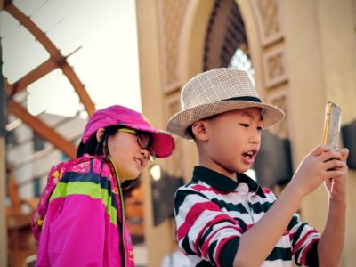 arched-window-asian-girl-boy-with-smartphone-250701