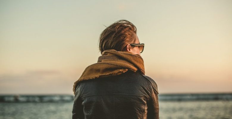 woman-by-the-water-wearing-leather-jacket-scarf-sunglasses