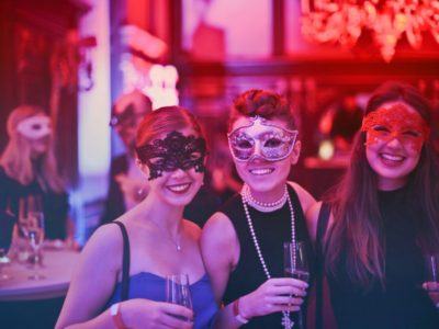 photo-of-three-women-wearing-masks-at-party