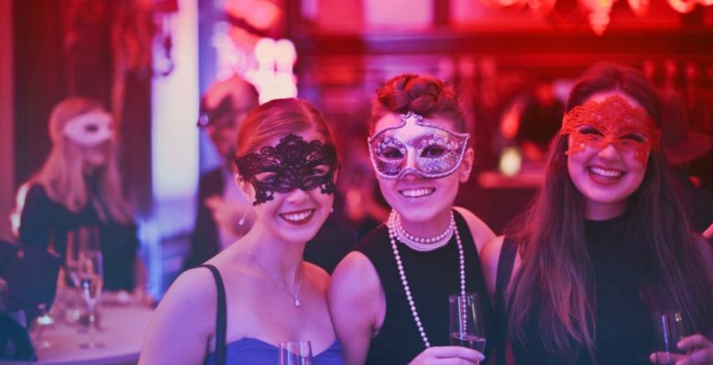 photo-of-three-women-wearing-masks-at-party